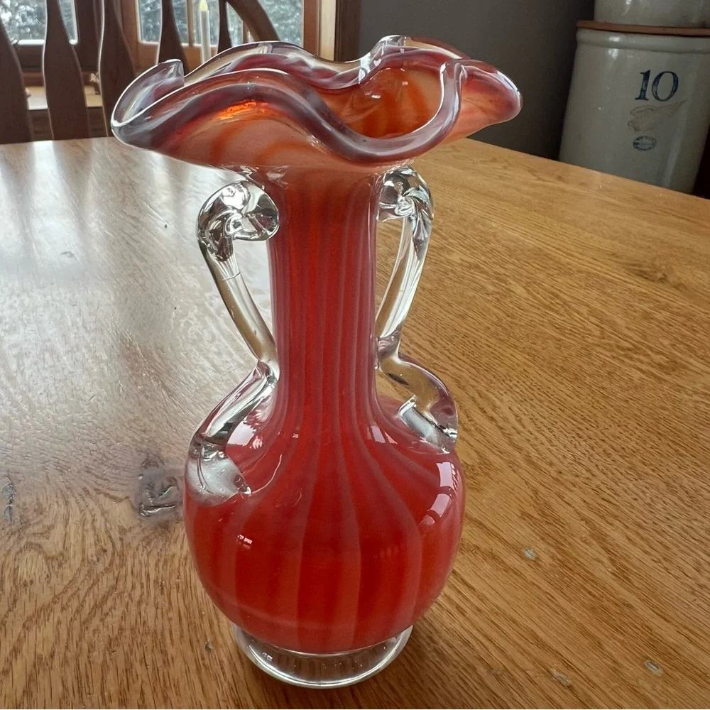 Victorian art glass vase with red and white swirl and ruffled rim.
